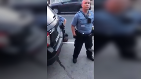 Disturbing NEW VIDEO shows cop standing guard as George Floyd dies