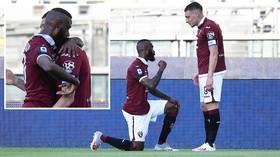 'They should have taken more care': Italian club Torino sparks racism row with pic of black player KNEELING before white teammate