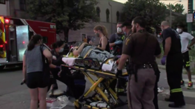 WATCH protesters carried on hood as car tries to break through blocked road in Bloomington, Indiana