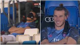 'He's paid €15 million a year for this': Playful Gareth Bale uses mask to SNOOZE on bench as Real Madrid play Alaves (VIDEO)