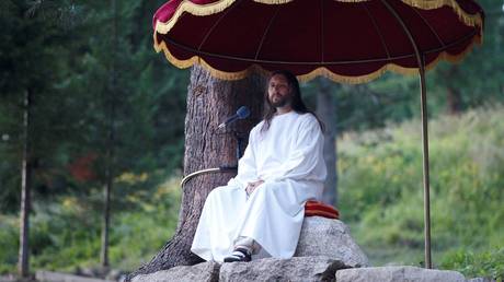 FILE PHOTO: Vissarion, who has proclaimed himself a new Christ, conducts a service during the "Holiday of Good Fruit" feast in the village of Obitel Rassveta (Cloister of Sunrise), some 640 km (398 miles) southeast of Russia's Siberian city of Krasnoyarsk, Russia August 18, 2010.