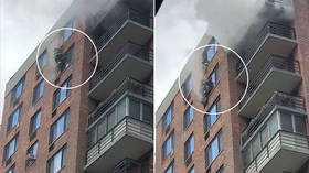 ‘I’m not going to let you fall’: WATCH fearless firefighter rescue woman trapped on 16th floor window by apartment blaze