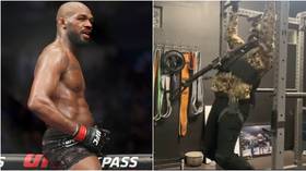 UFC star Jon Jones works out in camo gear with GUN strapped to his chest as Dana White says former champ is ‘ready’ for return
