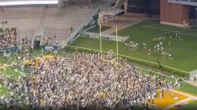 WATCH: Overjoyed Baylor fans storm field in Texas after NCAA title win... but predictable Covid sniping is quick to follow