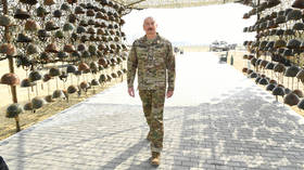 Azerbaijan’s president poses with helmets taken from fallen Armenian soldiers at opening of museum to bloody Nagorno-Karabakh war