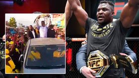 Francis Ngannou mobbed on return to Cameroon as UFC heavyweight king hands belt to his mom amid wild scenes on streets (VIDEO)