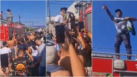 Newly-crowned UFC champ Oliveira receives hero’s welcome by favela community in Brazil after stunning title win (VIDEO)