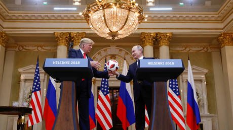 Russian President Vladimir Putin gifts a football to his US counterpart Donald Trump after a meeting in Helsinki, Finland, July 16, 2018.
