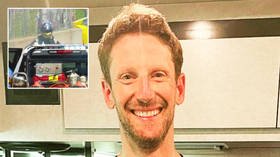 A one-man fire department: Roman Grosjean jokes with fans after firefighting crashed race car months after horrific crash (VIDEO)