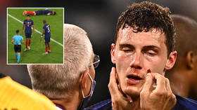 Knocked out cold: Anger after France defender is allowed to play on despite losing consciousness in sickening collision (VIDEO)