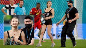 Money walks: Scantily clad pitch invader who interrupted Belgium and Finland at Euro 2020 was advertizing cryptocurrency