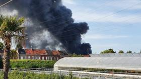 Massive column of smoke visible for MILES as huge fire rages through warehouse in northern France (VIDEOS)