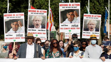 FILE PHOTO: Climate Coalition protesters demonstrate 100 days ahead of the COP26 climate summit, in London