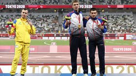 Keeping his distance: Wary Ukrainian Paralympian SNUBS Russian rivals on podium following military backlash against high jumper