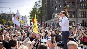 WATCH tens of thousands march against vaccine passports in Amsterdam