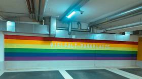 ‘That’s right straights, back of the bus!’: German car park ridiculed for installing rainbow-painted spaces for LGBT and migrants