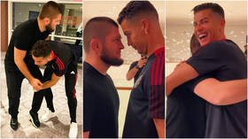 Intense face-off: Cristiano Ronaldo laughs after playfully wrestling UFC pal Khabib Nurmagomedov before stare-down and hug (VIDEO)