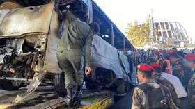 Twin explosions hit army bus in Damascus, killing over a dozen people