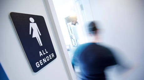FILE PHOTO: A bathroom sign welcomes both genders at a coffee shop in Durham, North Carolina, May 3, 2016  Reuters / Jonathan Drake