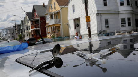 A full syringe, empty syringe and spoon sit on the roof of the car in the US.  Reuters / Brian Snyder
