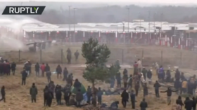 Polish police deploy water cannon to stop migrants storming Belarus border fence, stun grenades also heard