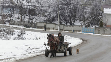 FILE PHOTO. A horse-drawn carriage is pictured on a street in Dragomiresti, Dambovita county, Romania.