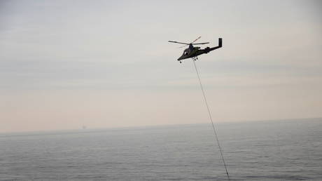 A firefighting helicopter gets water in the ocean to fight the Alisal fire, on the Gaviota coast near Santa Barbara, California, US, October 14, 2021