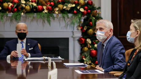 Anthony Fauci (C) and other White House officials meet with President Joe Biden, in the White House in Washington, DC, December 16, 2021.