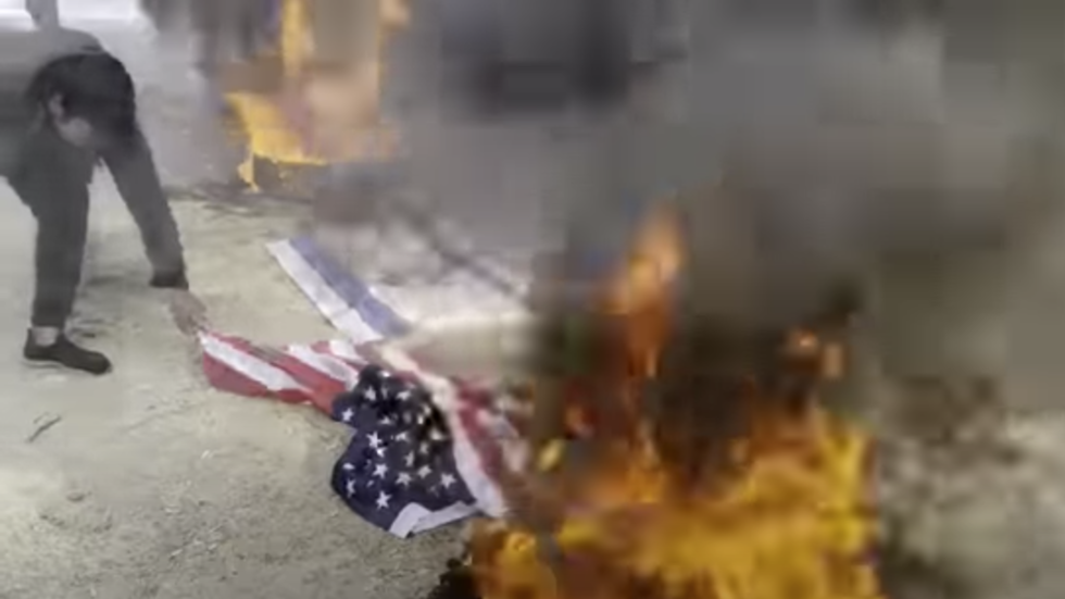 Protesters mourn assassinated general by burning US flags — RT World News