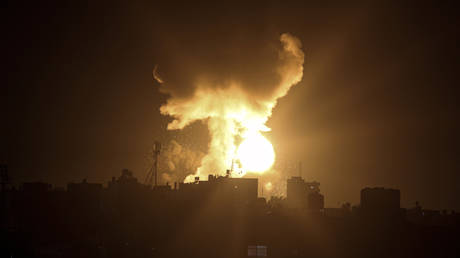 An explosion caused by Israeli airstrikes is seen in the town of Khan Younis, southern Gaza Strip, Sunday Jan, 2, 2022.