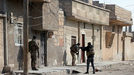 Kurdish-led militias fight terrorists on the streets of Hasaka, Syria, on January 22, 2022.