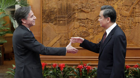 FILE PHOTO: US Deputy Secretary of State Antony Blinken shakes hand with Chinese Foreign Minister Wang Yi. © Andy Wong - Pool / Getty Images