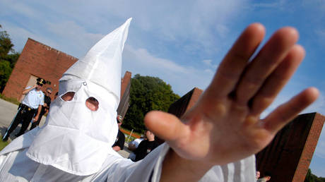 FILE PHOTO: A member of the Ku Klux Klan salutes during an American Nazi Party rally at Valley Forge, Pennsylvania, September 2004 Â© Getty Images /  William Thomas Cain