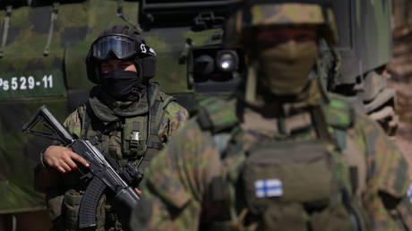 Finnish soldiers are shown participating in a military exercise near Rovaniemi, Finland.
