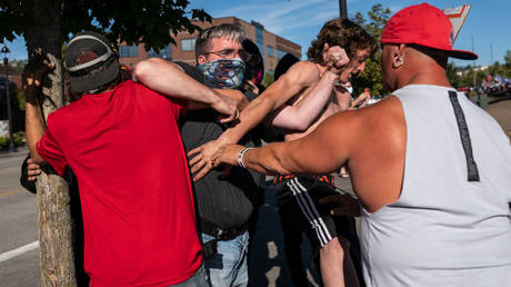 A Black Lives Matter protestor is shown scuffling with Donald Trump supporters at an August 2020 rally for the then-president in Clackamas, Oregon.