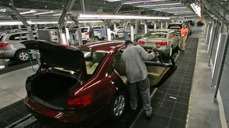 FILE PHOTO: Hyundai Motor Company employees put the finishing touches on vehicles at the Montgomery plant, Alabama, February 1, 2008