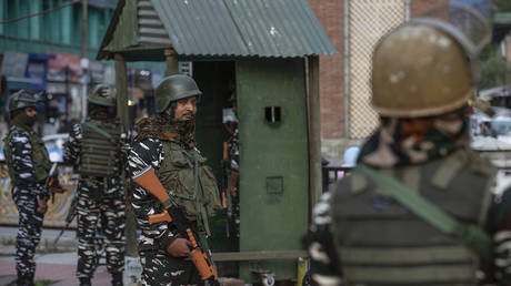 FILE PHOTO: Indian paramilitary troopers stand guard at a market place in Srinagar city, the summer capital of Indian-controlled Kashmir, October 11, 2021.