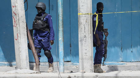 Security officers patrol at the the site of explosions in Mogadishu on August 20, 2022.