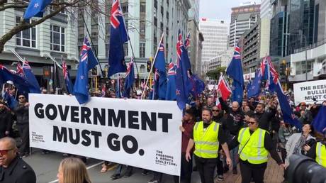Protesters march toward parliament during a demonstration against government Covid-19 policies, in Wellington, New Zealand, August 23, 2022.