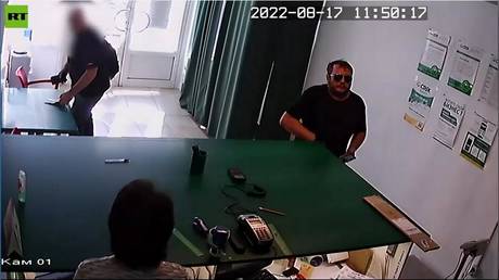 Screenshot from an FSB video allegedly showing Bogdan Tsiganenko as he receives a package with fake car plates.