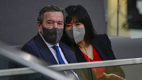 Former German chancellor Gerhard Schroeder and his wife Schroeder-Kim So-yeon sit in the tribune prior to a session at the Bundestag on December 8, 2021, Berlin, Germany