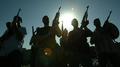 FILE PHOTO: Members of a private security company pose on the rooftop of a house in Baghdad, 18 September 2007.