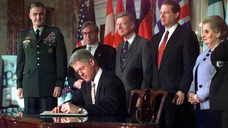FILE PHOTO: President Clinton signs a protocol of accession to the Washington Treaty for Poland, Hungary and Czech Republic for the countries to join NATO, Washington, February 11,1998