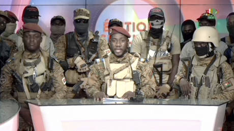 In this image from video broadcast by RTB state television, coup spokesman Capt. Kiswendsida Farouk Azaria Sorgho reads a statement in a studio in Ougadougou, Burkina Faso, on September 30, 2022