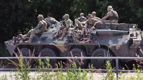 FILE PHOTO: Ukrainian soldiers travel down a road  near Druzhkivka, the Donetsk People's Republic (DPR), on June 19, 2022.