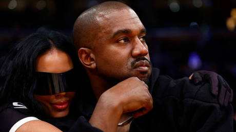 Kanye West is shown attending an NBA game with girlfriend Chaney Jones last March in Miami.