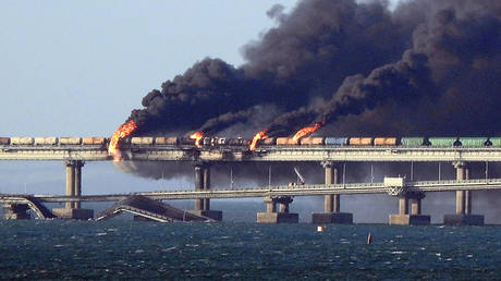 Black smoke billows from a fire on the Kerch bridge that links Crimea to Russia, after a truck exploded, near Kerch, on October 8, 2022.