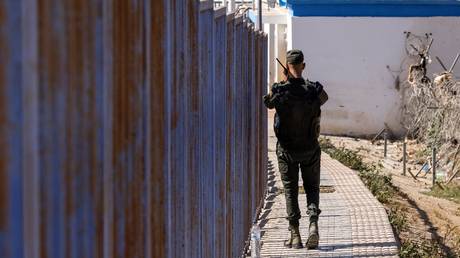 A Moroccan security forces guard patrols the border fence separating Morocco and Spain's North African enclave of Melilla, June 26, 2022