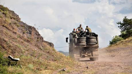 FILE PHOTO: Armenian servicemen transport used tyres in the back of a truck on the Armenian-Azerbaijani border near the village of Movses.
