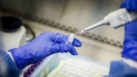 FILE PHOTO: A laboratory technician prepares Covid-19 patient samples for semi-automatic testing at a laboratory in Lake Success, New York, March 11, 2020